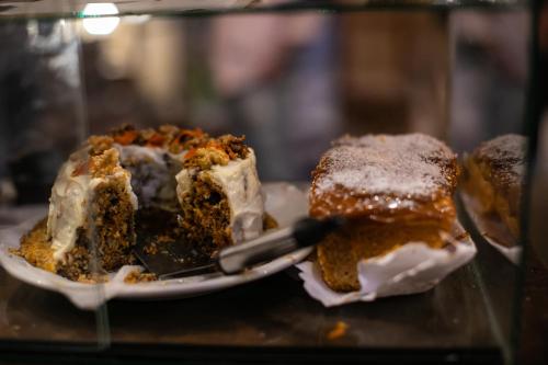 two pieces of cake on a plate on a table at Pura Vida Mae YerbaBuena in Yerba Buena