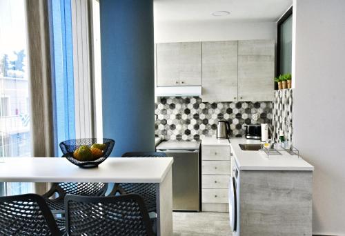 a kitchen with a white table and chairs at Zoes Apartment Kos Town in Kos Town