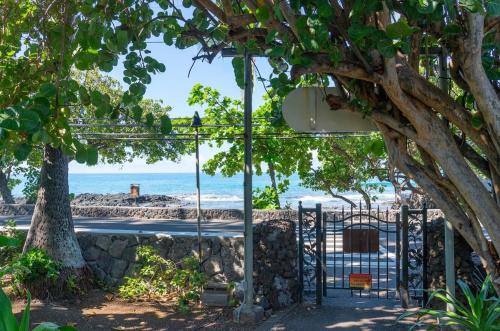 a gate with a view of the beach at Hale Moana, Unit #110 Kona Islander Inn in Kailua-Kona