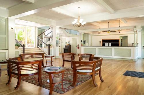 a dining room with a table and chairs and a kitchen at Hale Moana, Unit #110 Kona Islander Inn in Kailua-Kona