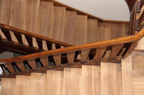 a wooden spiral staircase in a building at Zum Schwarzen Löwen in Altdorf