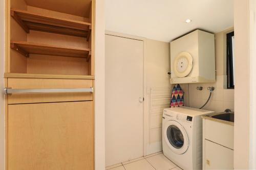 a small kitchen with a washing machine and a washer at Ocean Boulevard in Alexandra Headland