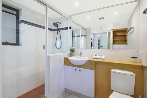 a bathroom with a toilet and a sink and a shower at Ocean Boulevard in Alexandra Headland