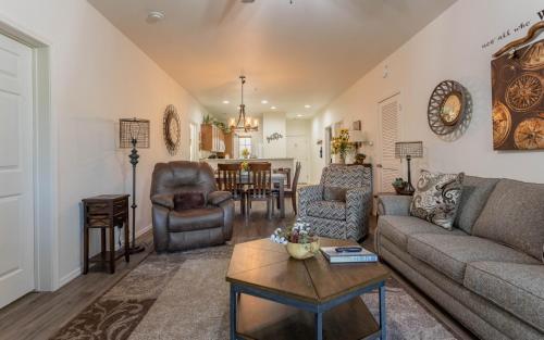 a living room with a couch and a table at Simple Serenity condo in Branson West