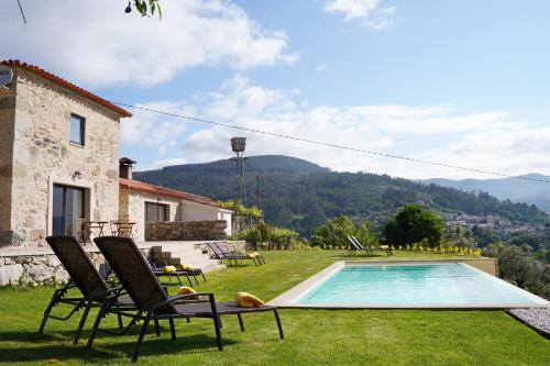 a villa with a swimming pool in a yard at Quinta da Enxurreira in Ponte de Lima