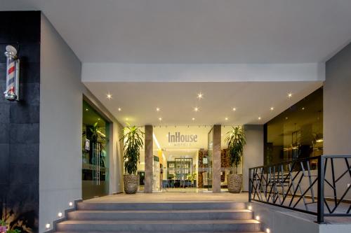 a store front of a building with lights on the stairs at InHouse Hotel Culiacán in Culiacán