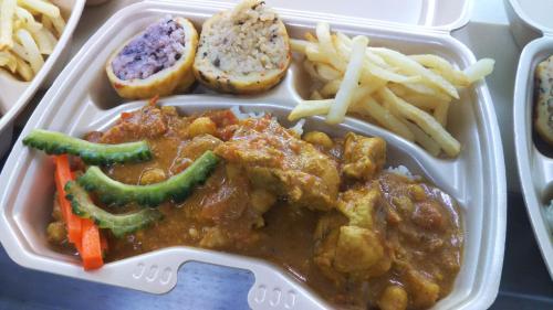 a plastic container of food with meat and french fries at Hanamuro Inn Aka Island in Zamami
