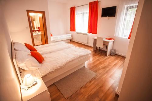 a small bedroom with a bed and a mirror at Rooms Lidija in Zagreb