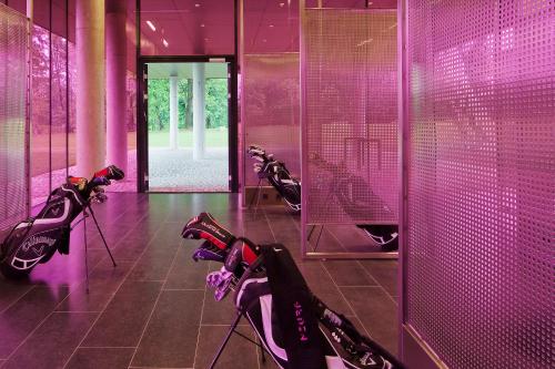 a room with purple walls and a row of scooters at Miura Hotel in Čeladná