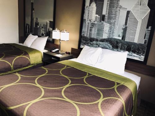 a hotel room with two beds and a large window at Super 8 by Wyndham Peru Starved Rock State Park in Peru
