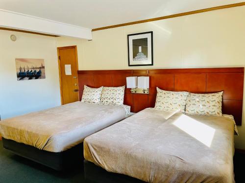 a hotel room with two beds in a room at Hunter's Friend Resort on Indian Point in Branson