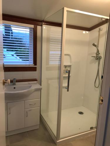 a bathroom with a shower and a sink at Tophouse Historical Inn Bed and breakfast in Saint Arnaud