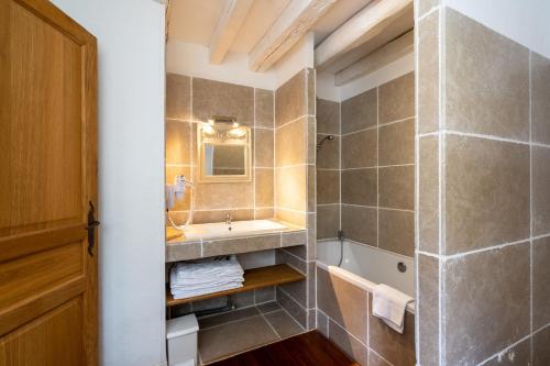 a bathroom with a sink and a mirror and a shower at Maison d'hôtes Moulin du Bas Pesé in Mont-près-Chambord