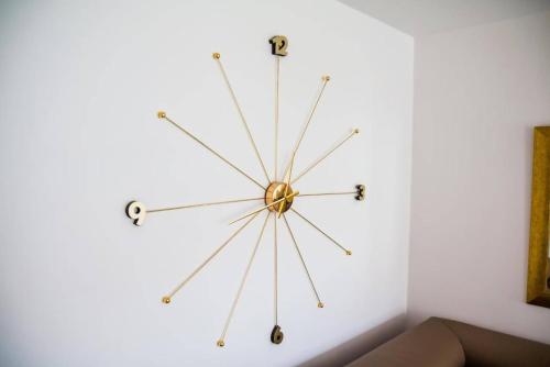 a large clock on a white wall at Perfect Stay - "Campari Glam Apartments" in Toruń