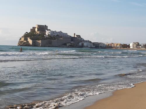a view of a beach with a castle in the water at La Mallada in Sant Jordi