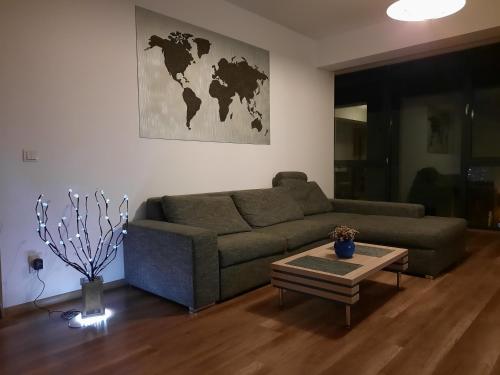 a living room with a couch and a table at Citadella Apartament in Târgu-Mureş