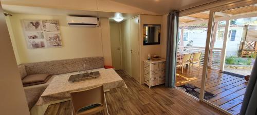 a small living room with a table and a kitchen at Mobile Homes Danijela in Amadria Park Trogir in Seget Vranjica