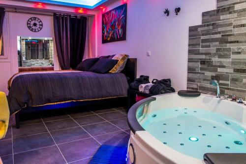 - une chambre avec un lit et une baignoire dans l'établissement LE SPAMOUREUX bien-être a deux, à Boussy-Saint-Antoine