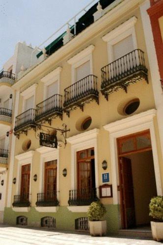 a large building with balconies on the side of it at Hotel La Española in Chipiona