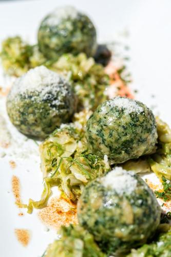 a close up of a plate of food with broccoli at Ansitz Velseck-Residence Hotel in Tires