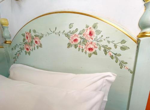 a bedroom with a floral headboard with a white bed at Milton Boutique Hotel - Adults Only in Lido di Jesolo