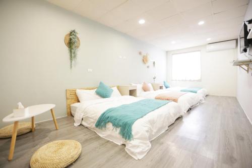 a bedroom with two beds and a table at 小巷微光 in Green Island
