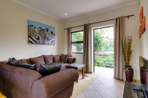 a living room with a couch and a window at Forest Lodge in St Lucia