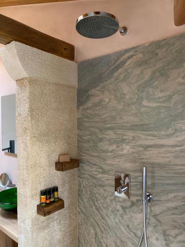 a shower in a bathroom with a marble wall at Casa Livieres in Chania Town