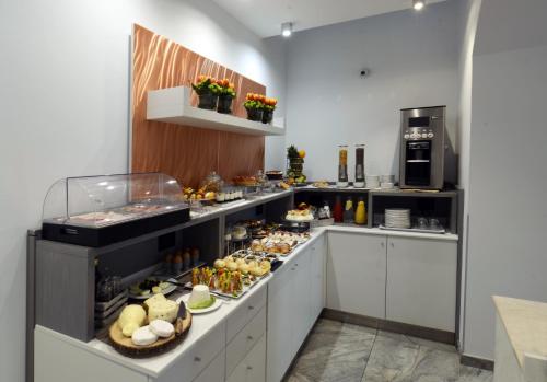 a kitchen with a bunch of food on display at Best Western Hotel Principe di Lampedusa in Palermo