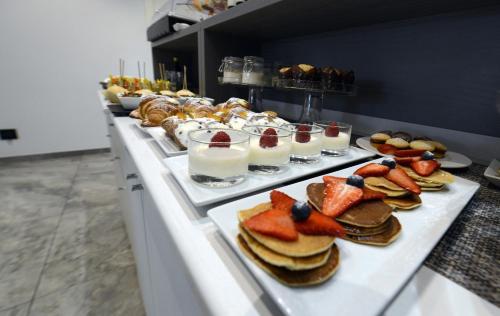 a buffet line with plates of food and desserts at Best Western Hotel Principe di Lampedusa in Palermo