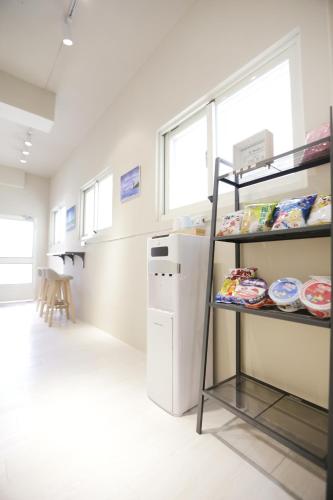 a room with a shelf and a refrigerator at 小巷微光 in Green Island