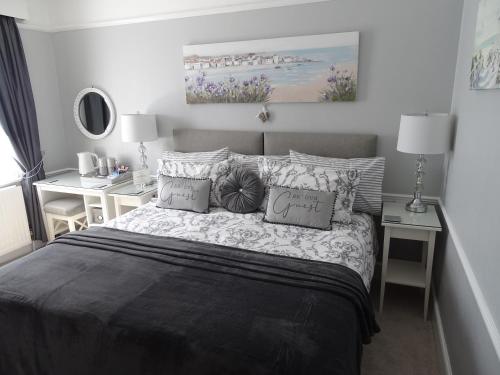 a bedroom with a bed with pillows on it at Linden Lodge Guest House in Weston-super-Mare