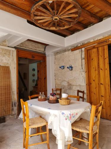 a dining room with a table with chairs and a ceiling at Kassandras place in Omodos village in Omodos