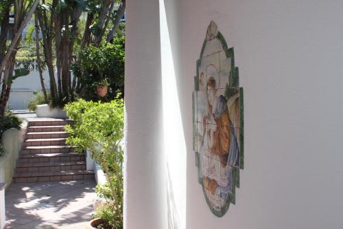 a painting on the side of a building with stairs at Villa Marinella in Ischia