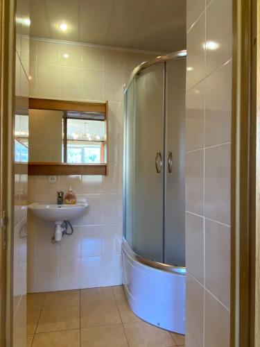 a bathroom with a shower and a sink at Садиба "Джерело" in Yaremche
