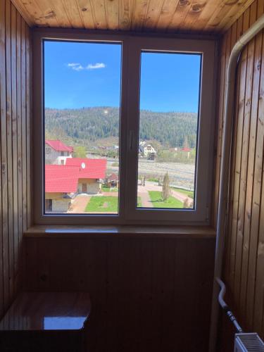 a window in a room with a view of a farm at Садиба "Джерело" in Yaremche
