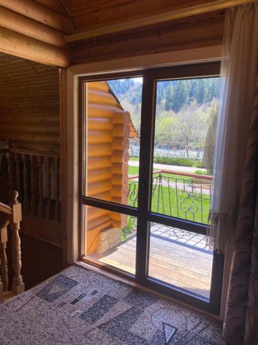 a window in a room with a view of a porch at Садиба "Джерело" in Yaremche