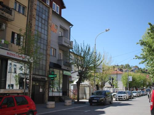 a busy city street with cars parked on the street at Ecco Superior in Novi Pazar