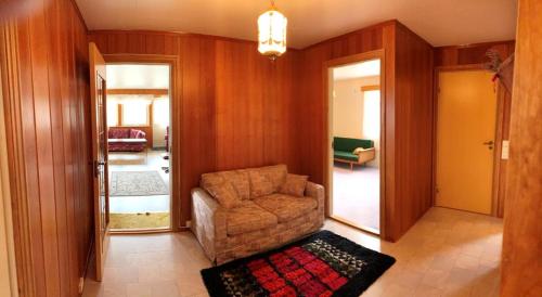 a living room with a chair and a mirror at Landlig hus på kysten in Tustna