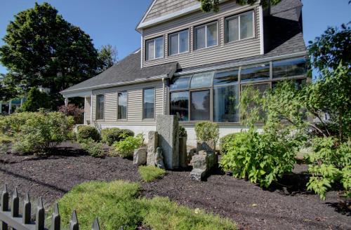 a house with a garden in front of it at Aspinquid Resort in Ogunquit