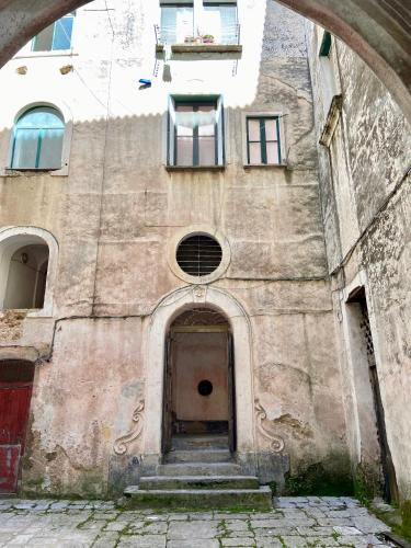 an old building with a door and a window at Antica Dimora Amalfi Coast in Scala