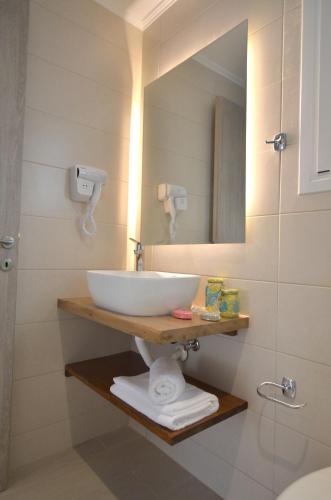 a bathroom with a sink and a mirror at Meltemi Studios in Vasiliki