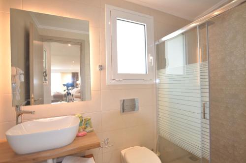 a bathroom with a sink and a toilet and a shower at Meltemi Studios in Vasiliki