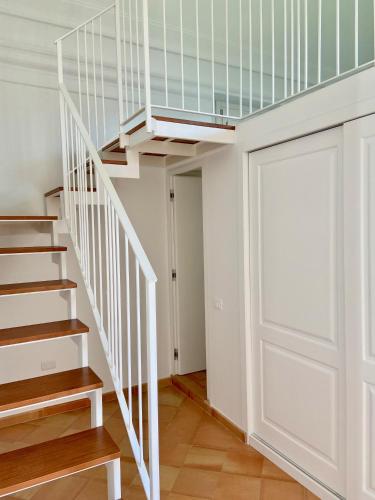 a white staircase with a white door in a room at Antica Dimora Amalfi Coast in Scala