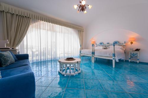 a room with a bed and a blue tile floor at Grand Hotel Le Rocce in Gaeta
