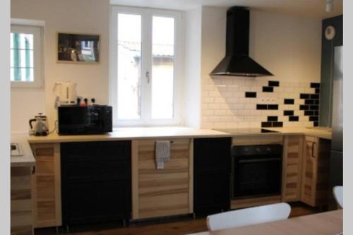 a kitchen with a counter with a microwave and a window at Résidence prestige - terrasse - 4 chambres - 3 SDB in Aubière