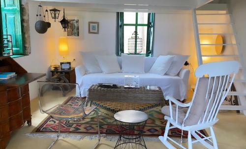 a living room with a couch and two chairs at Hypate, traditional island cottage in Halki