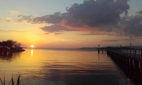 a sunset over a body of water with a pier at Casa Barbara in Sant Arcangelo