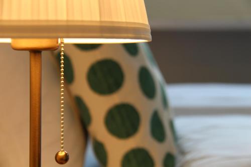 a close up of a lamp with a polka dot shade at Zum Schwarzen Löwen in Altdorf