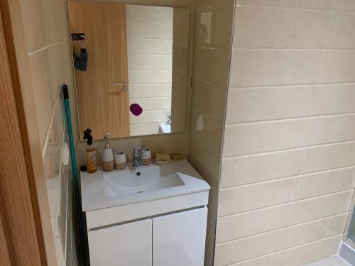 a small bathroom with a sink and a shower at Asilah marina golf in Asilah